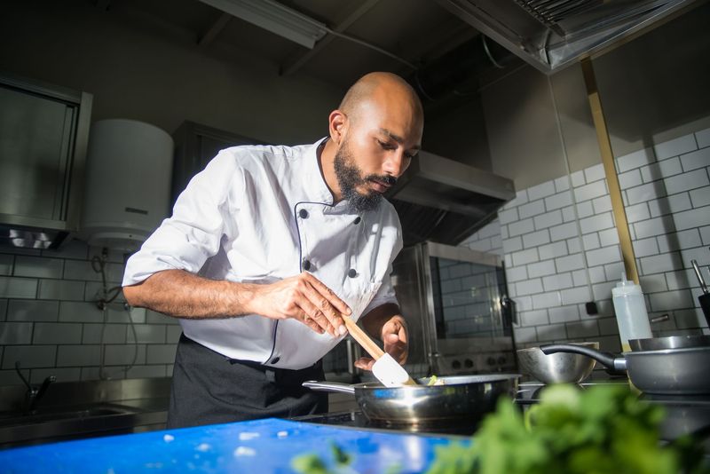 Private chef plating a composed course for an intimate dinner at home