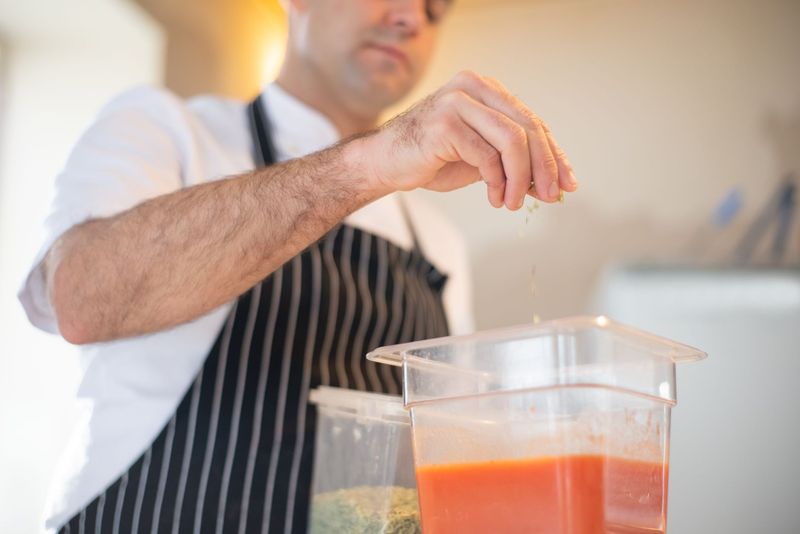 Private chef serving a tasting course during an intimate dinner at home