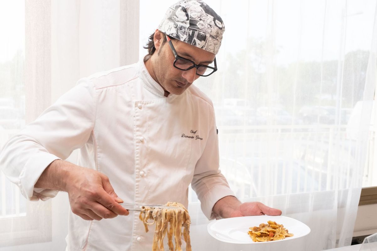 Chef plating a refined appetizer for a catered event