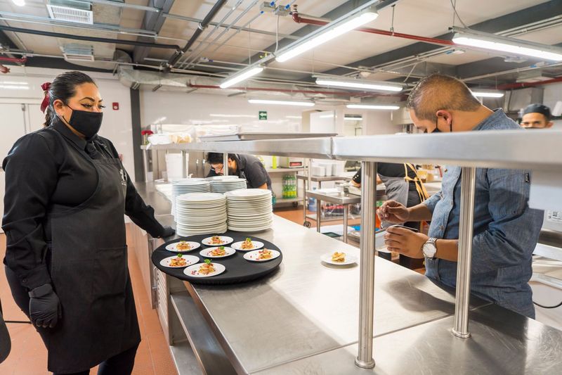 Private chef serving a plated dinner in an elegant home dining room