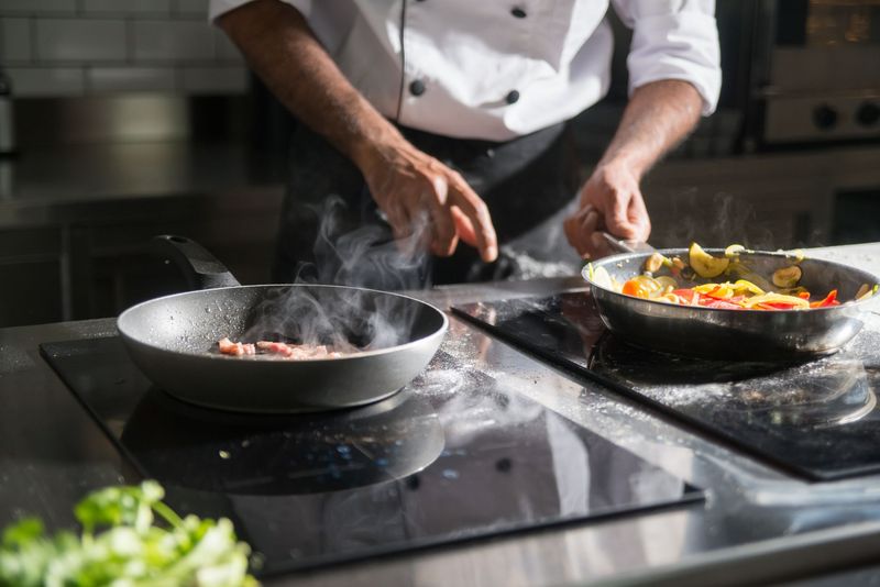 Chef portioning gourmet meals into delivery containers
